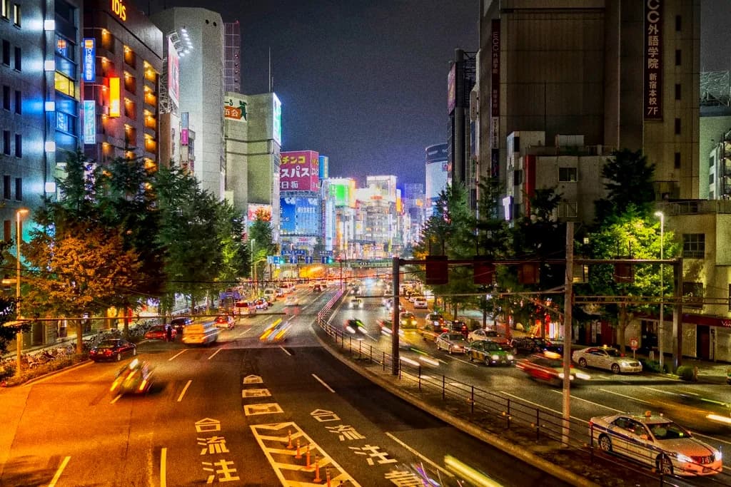 A wide city boulevard at dusk with long light trails from traffic