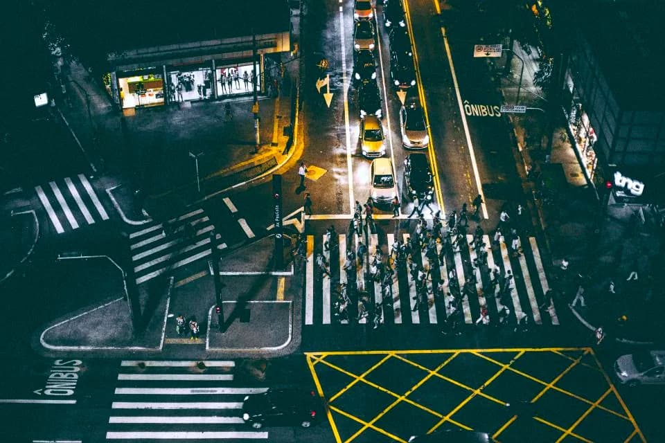 An overhead view of a night crossing marked with yellow lines